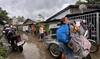 Residents carrying their belongings evacuate their homes ahead of the arrival of Super Typhoon Fung-wong in Tuguegarao City.